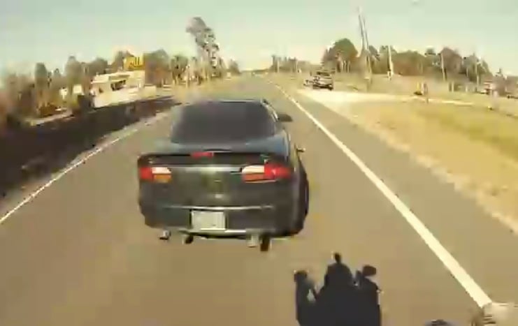 POV Video: Motorcyclist Hitches a Ride on a Camaro the Hard Way
